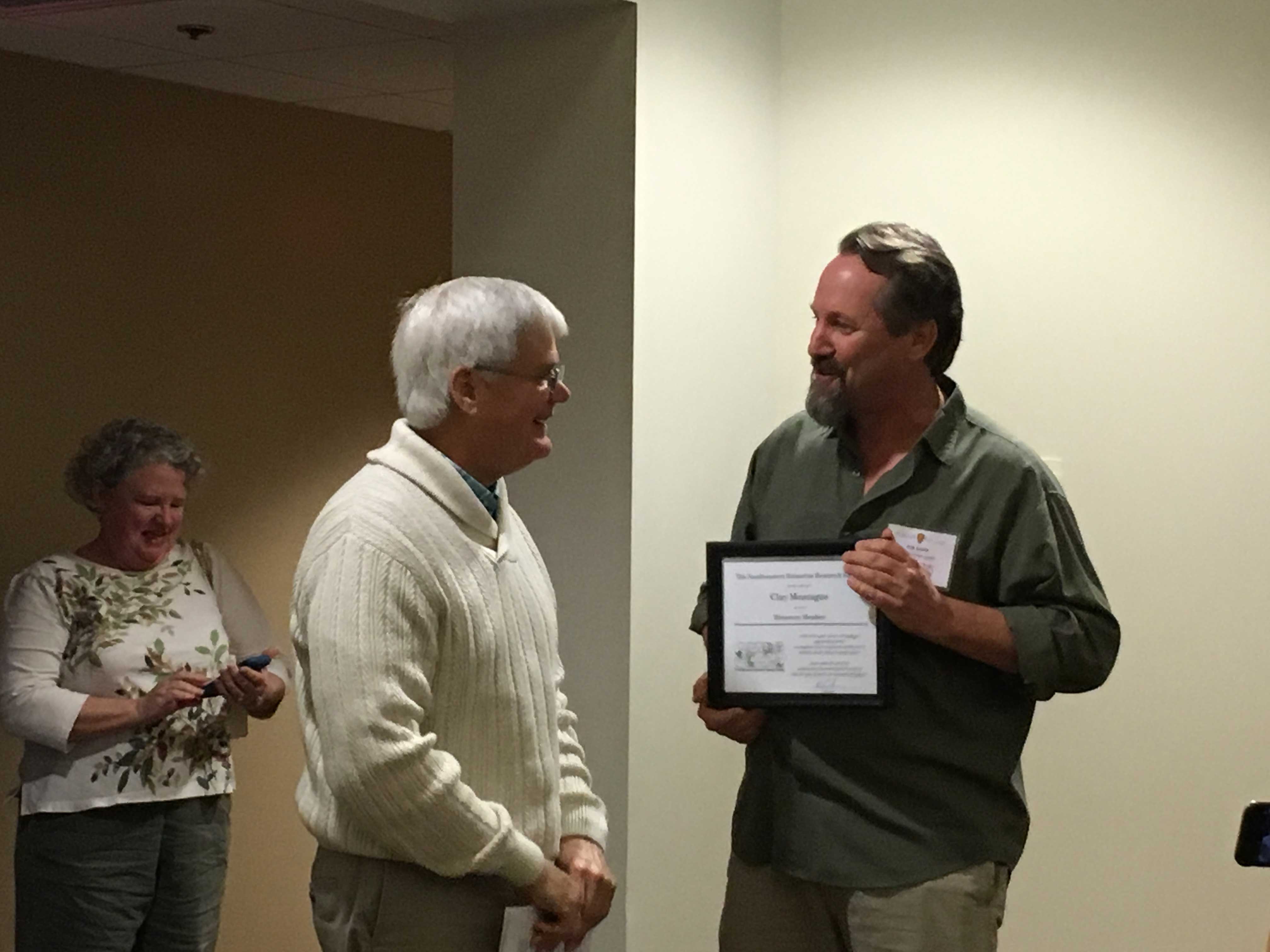 SEERS President Erik Smith (right) presents longtime member and former board member Clay Montague (center) with Honorary Membership.